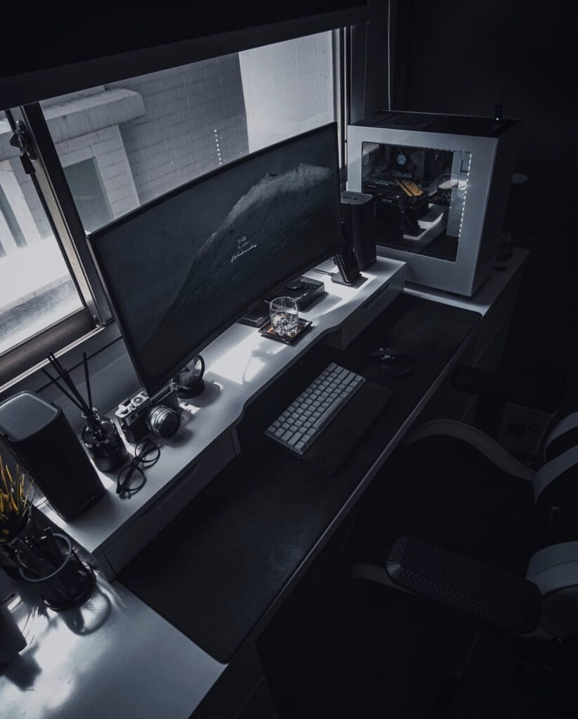 shot from above workspace with ultrawide monitor in Singapore